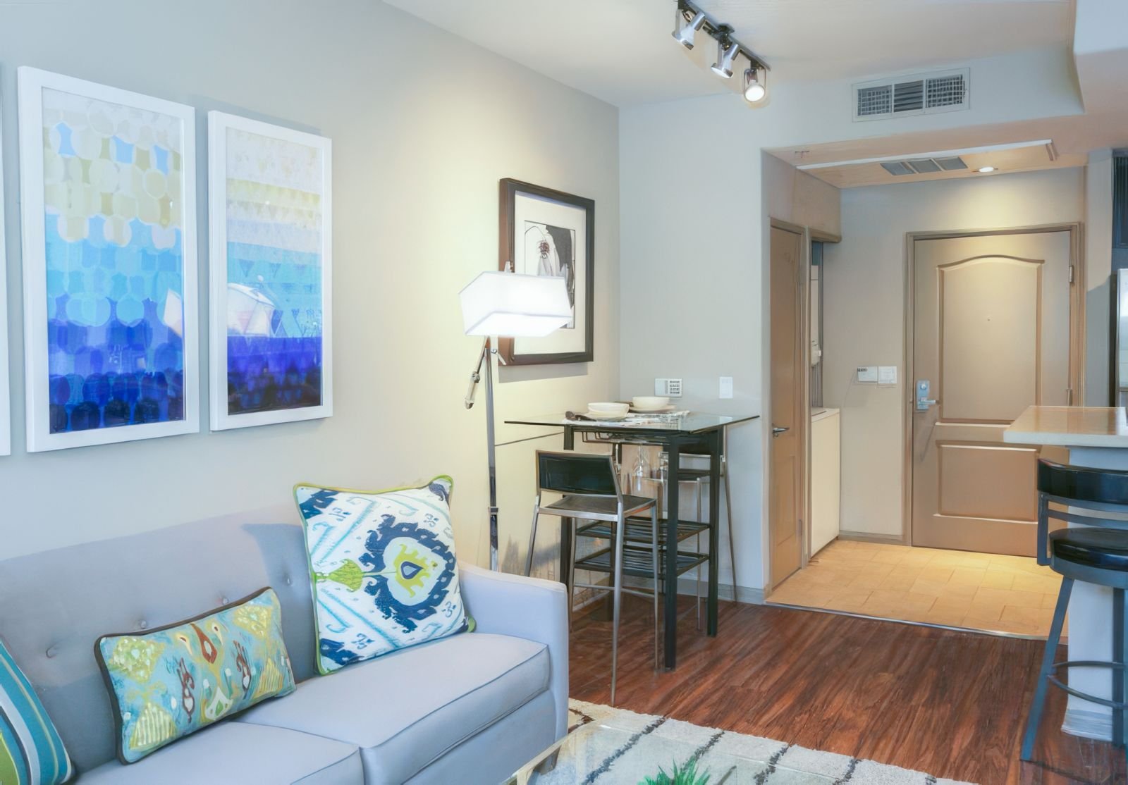 Bright living room of City Lights on Fig apartments in Downtown LA showcasing a plush couch, a sleek coffee table, and a chic bar for casual gatherings
